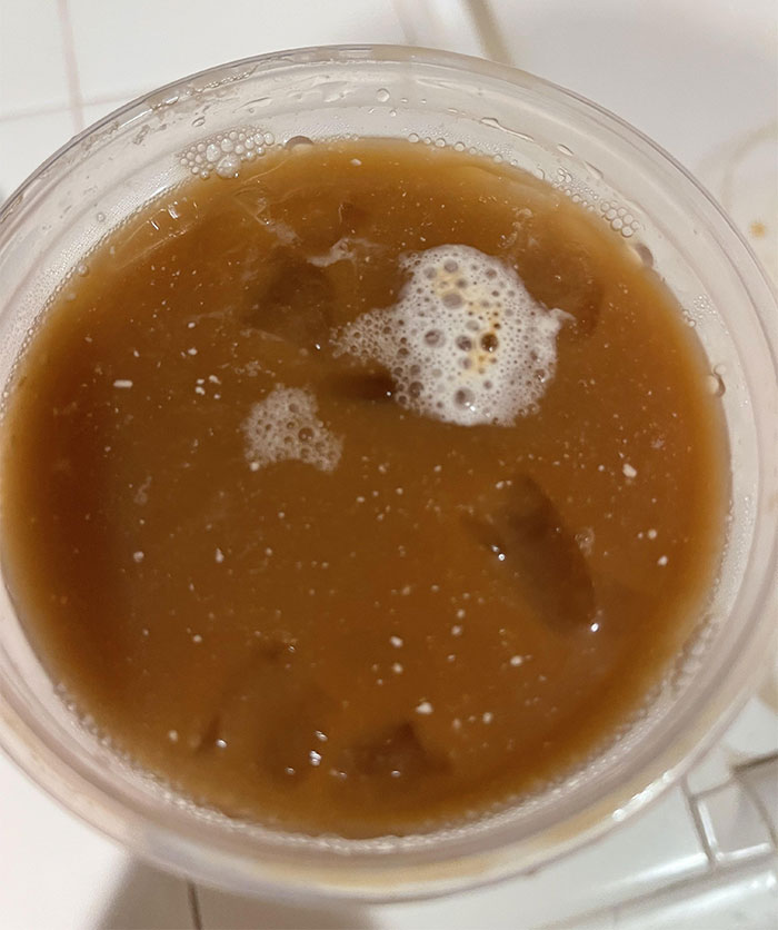Close-up of an iced coffee with white foam, related to woman takes revenge on boyfriend. Close-up of an iced coffee with white foam, related to woman takes revenge on boyfriend.