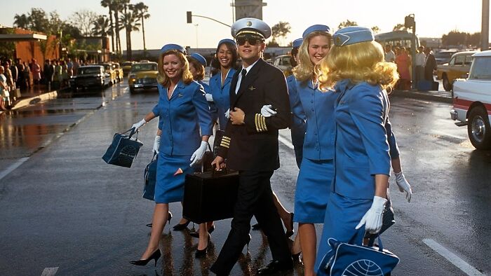 A pilot walks with several flight attendants in uniform on a street, showcasing curious facts.