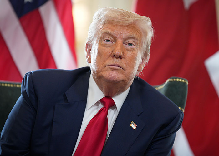 Donald Trump in a dark suit and red tie, looking seriously at the camera, related to the unhinged video. Donald Trump in a dark suit and red tie, looking seriously at the camera, related to the unhinged video.