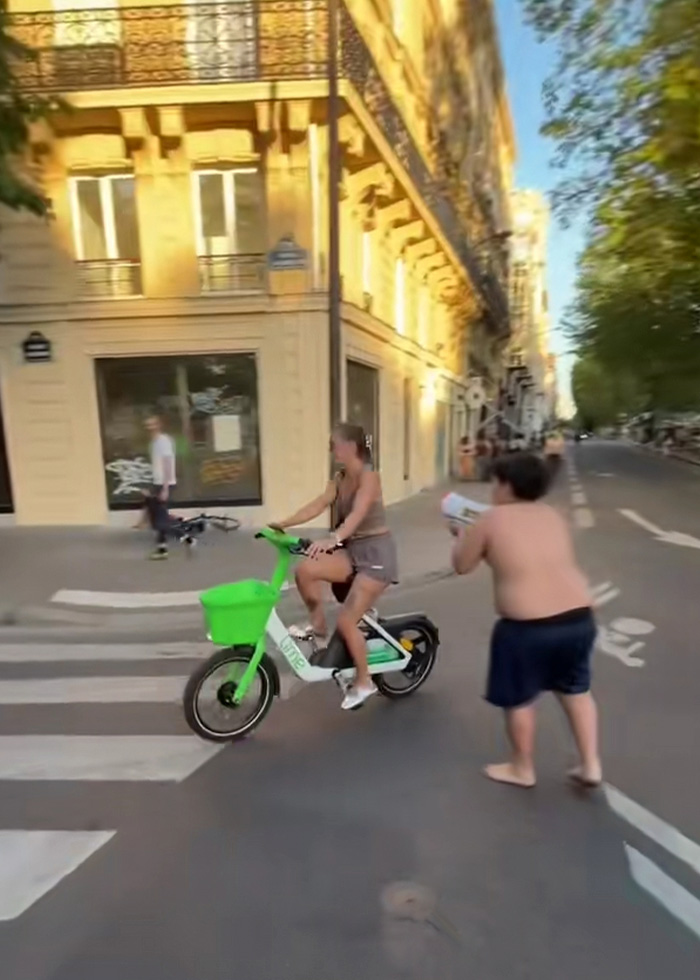 A 14-year-old boy with a water toy chases a woman on a bicycle, accused of terrorizing tourists. A 14-year-old boy with a water toy chases a woman on a bicycle, accused of terrorizing tourists.