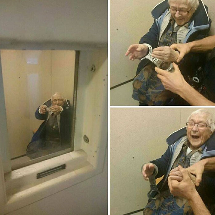 An aww-worthy elderly woman smiles while being playfully handcuffed by officers, lifting spirits.
