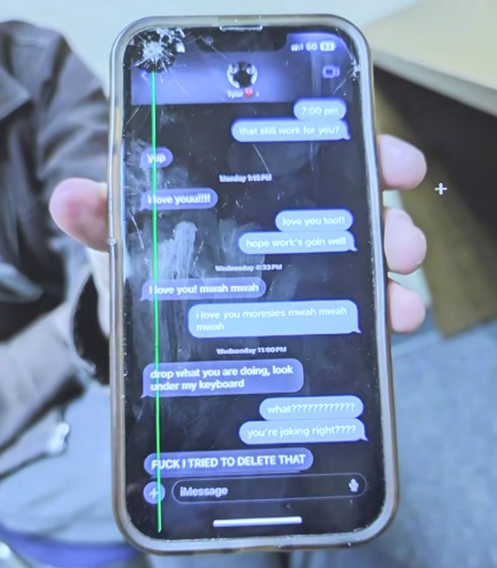 A cracked smartphone screen displays a text message exchange from the police interview. A cracked smartphone screen displays a text message exchange from the police interview.