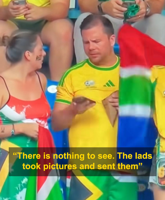 The World Cup couple after the woman questions the man about his phone, part of their viral World Cup moment. The World Cup couple after the woman questions the man about his phone, part of their viral World Cup moment.
