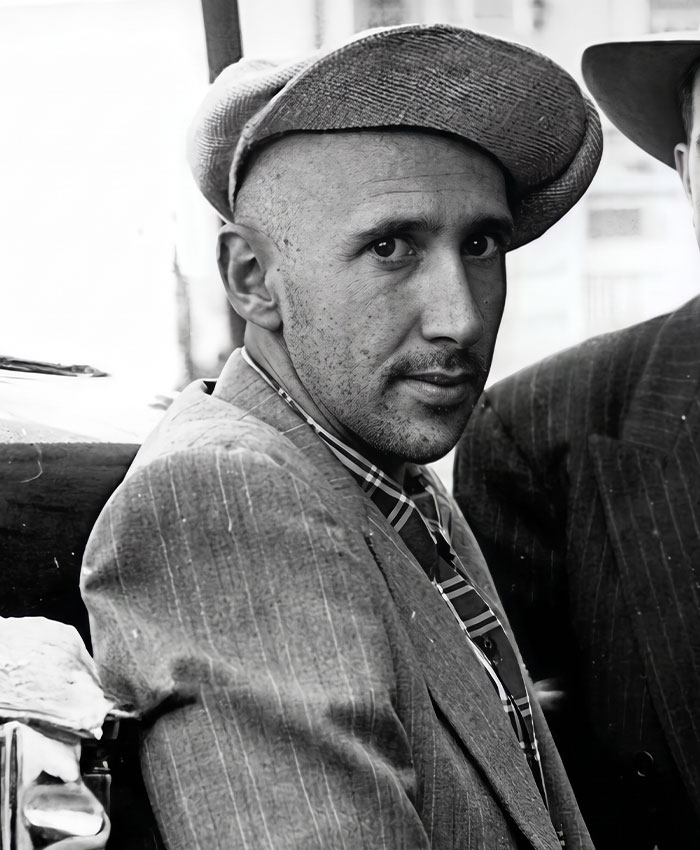 Black and white portrait of a 24-year-old man, a national nightmare, in a suit and hat after a street fight. Black and white portrait of a 24-year-old man, a national nightmare, in a suit and hat after a street fight.