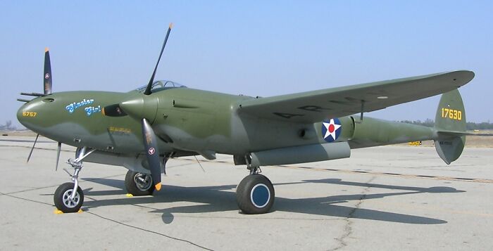 A P-38 Lightning airplane on an airfield, a captivating piece of history facts.