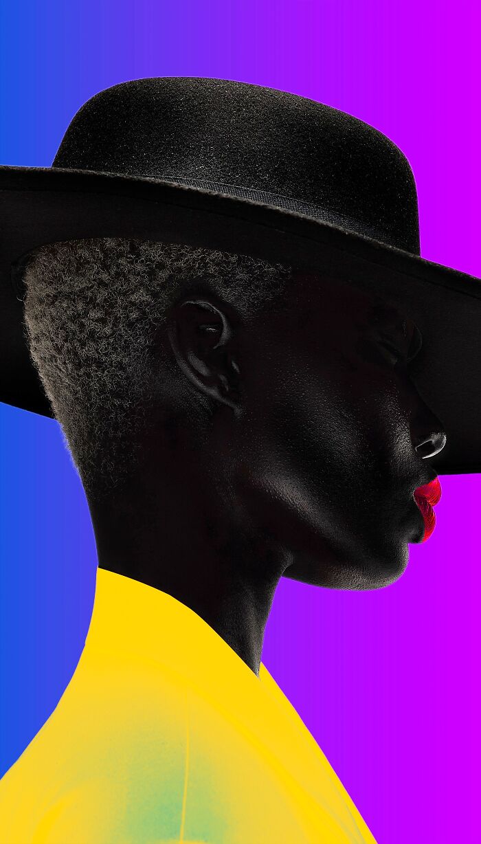 A striking profile of a person with dark skin and red lips wearing a black hat, a remarkable color photo from the reFocus Contest.