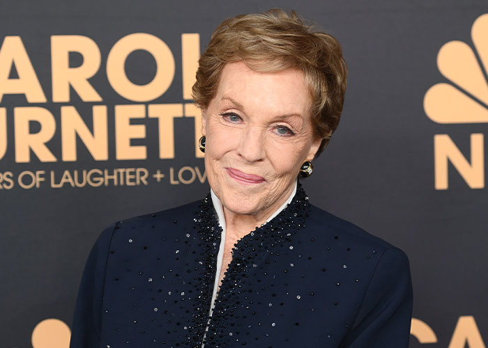 Julie Andrews smiling at an event, sparking Disney backlash with her glowing portrait. Julie Andrews smiling at an event, sparking Disney backlash with her glowing portrait.