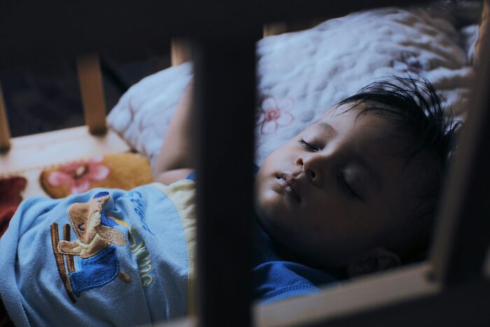 A baby sleeping soundly in a crib. This moment perfectly captures how men freak out in a woman's home.