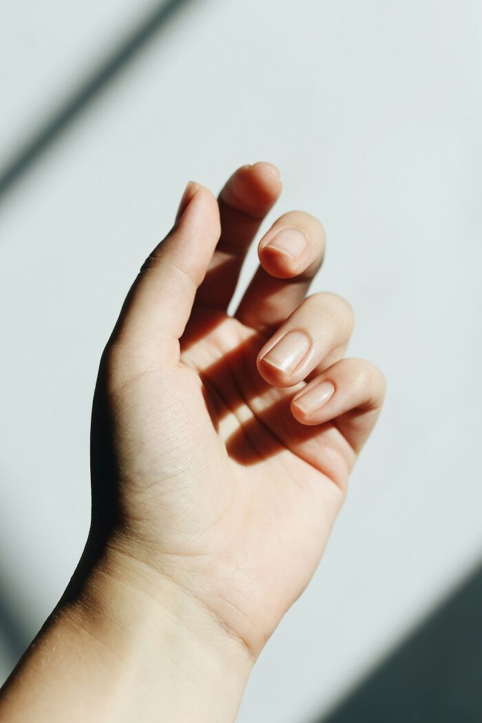 Open hand in sunlight, symbolizing vulnerability when sharing deep secrets with internet strangers.