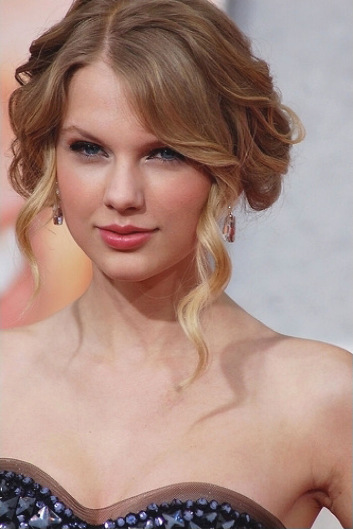 A close-up of a blonde celebrity with blue eyes and an updo, wearing a strapless top, representing disillusioned celebrities.