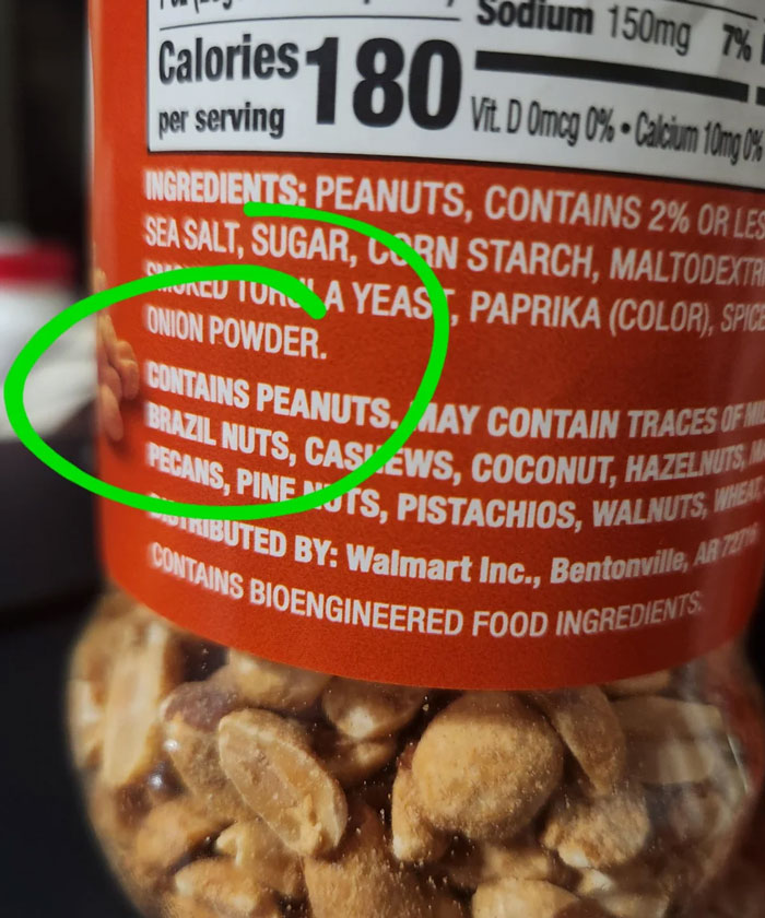 A hilariously dumb warning label showing a peanut jar with ingredients and a green circle highlighting onion powder.