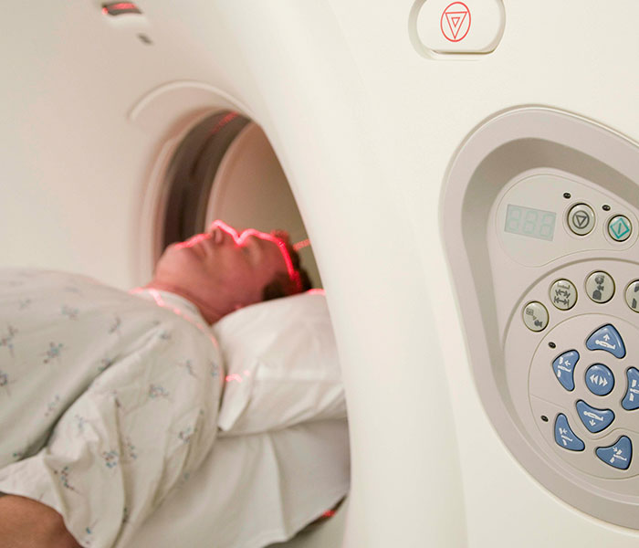 Patient undergoing a CT scan to investigate cancer symptoms, often dismissed as normal aging. Patient undergoing a CT scan to investigate cancer symptoms, often dismissed as normal aging.