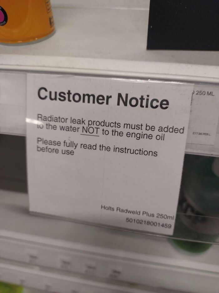 A customer notice sign about adding radiator leak products to water, not engine oil, due to cultural decline.