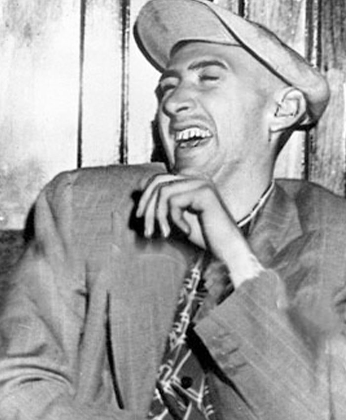A 24-year-old man, a national nightmare, laughing in a striped suit and hat, after a petty street fight. A 24-year-old man, a national nightmare, laughing in a striped suit and hat, after a petty street fight.