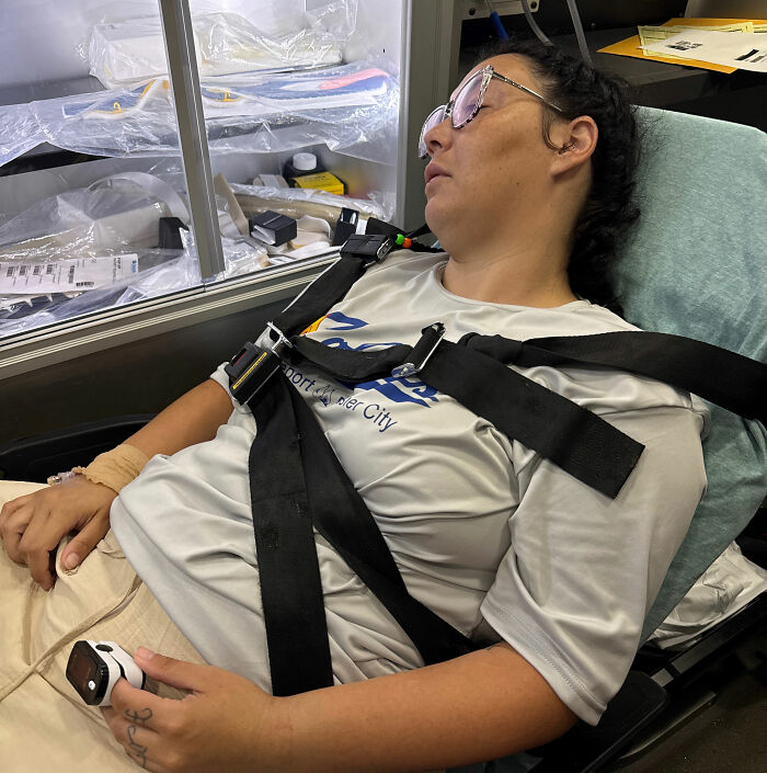 Louisiana woman with catastrophic cruise injury in ambulance, secured by straps with pulse oximeter on finger. Louisiana woman with catastrophic cruise injury in ambulance, secured by straps with pulse oximeter on finger.