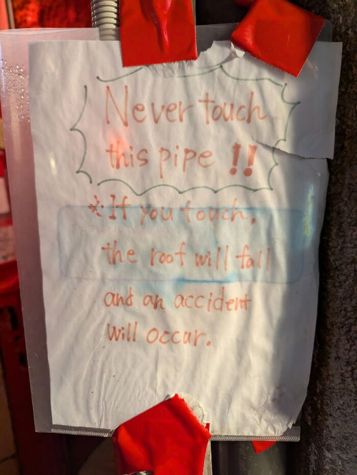 A handwritten sign in Japan: Never touch this pipe, if you touch, the roof will fall, a hilarious example of lost in translation.