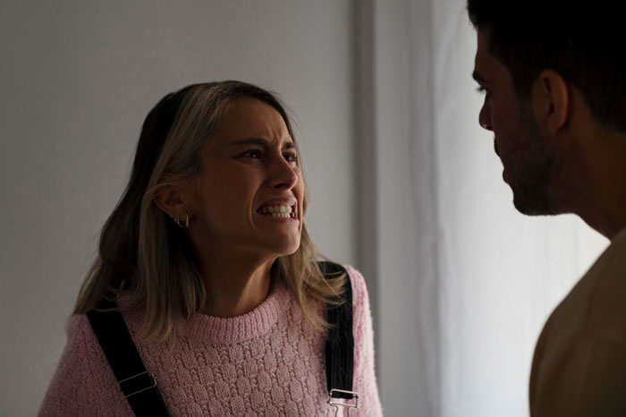 A distressed woman with an angry expression, reflecting the emotional turmoil after having a baby.