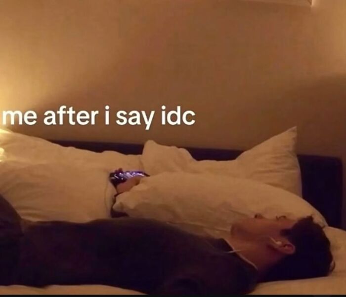 A humorous meme of a person lying in bed, looking thoughtful, after saying I don't care.