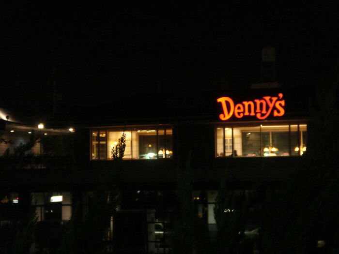 A Denny's restaurant lit up at night, creating a terrifying moment to leave now.