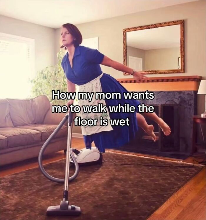 A woman floating above a vacuum cleaner to avoid a wet floor, a relatable meme.