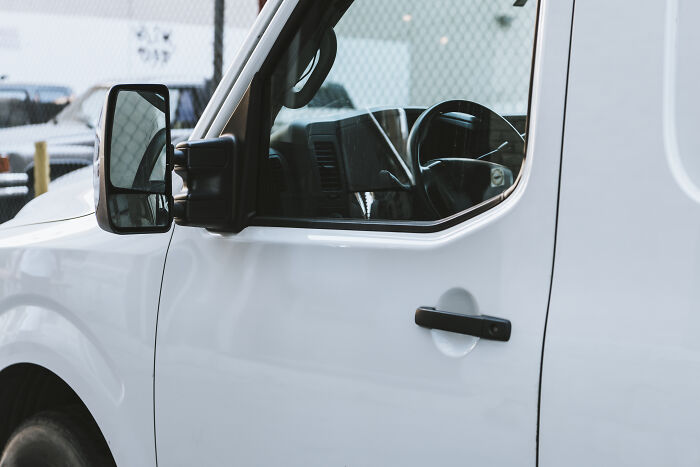 Side view of a white commercial van, possibly related to why someone got fired from their job.