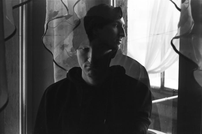 A double exposure of a man creates a mysterious and creepy effect, capturing strange things.