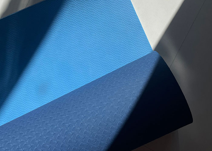 Blue yoga mat on the floor, possibly in a man's home, where women might feel the need to leave.
