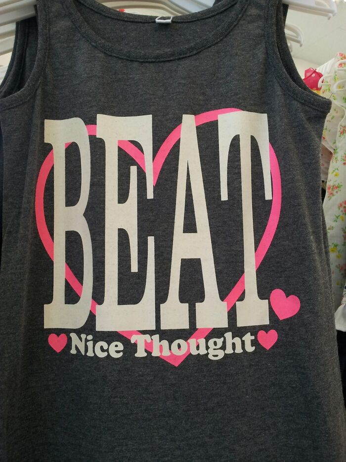 A grey tank top with the phrase BEAT Nice Thought and pink hearts, an example of getting lost in translation in Japan.