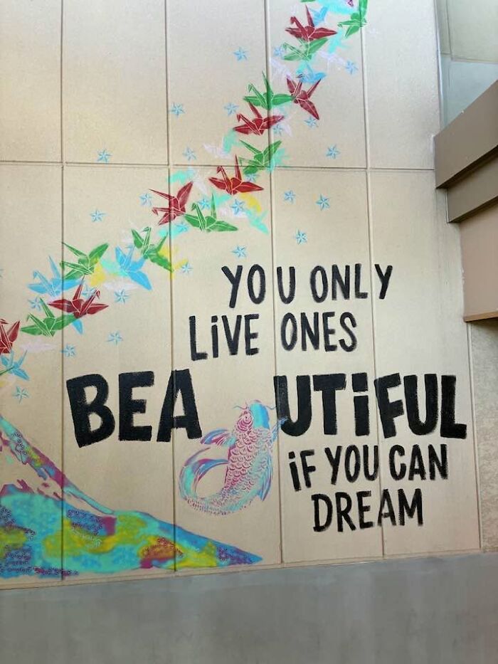 A wall mural with a hilarious example of getting lost in translation with the phrase 'YOU ONLY LIVE ONES BEAUTIFUL IF YOU CAN DREAM'.