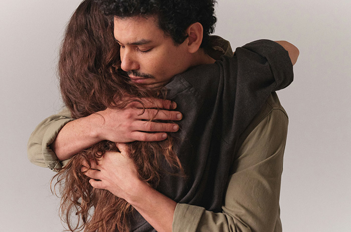A couple embracing, depicting the emotional challenges when a woman feels like the third wheel in her marriage due to her MIL. A couple embracing, depicting the emotional challenges when a woman feels like the third wheel in her marriage due to her MIL.