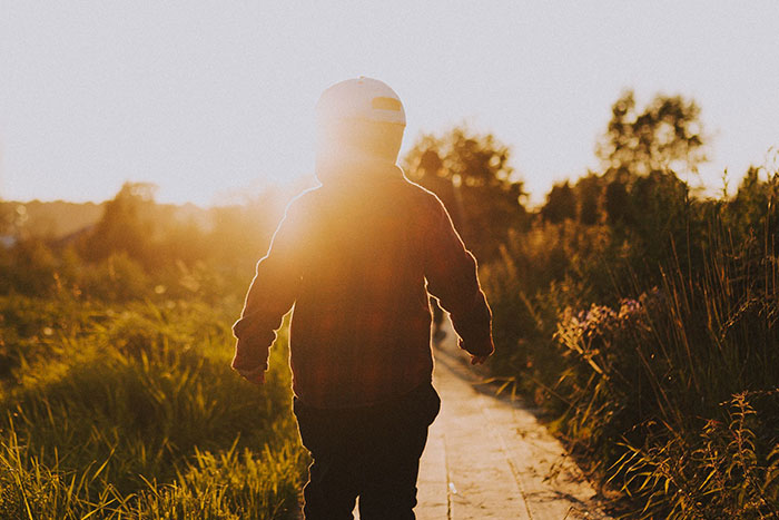 A child walks away into the sunset, an image evoking the innocence of kids before names become significant.