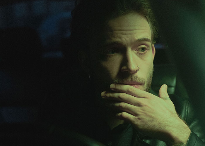 A man with a pensive look, possibly contemplating a reality break.