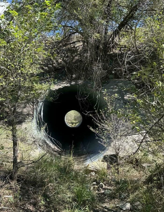 A photo that confused people: a pipe entrance appearing as a circular reflection in a dark tunnel.