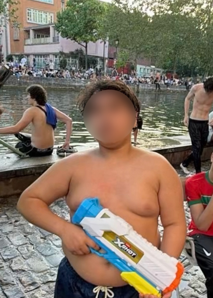 A 14-year-old boy holds a water toy, accused of terrorizing tourists. A 14-year-old boy holds a water toy, accused of terrorizing tourists.