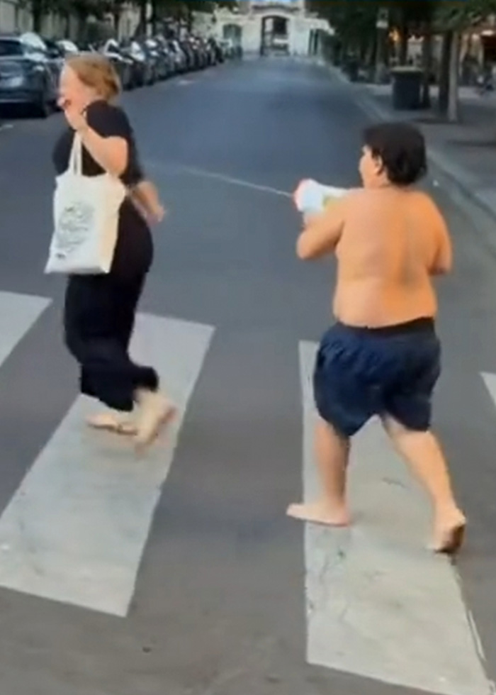 14-year-old boy spraying a water toy at tourists in a controversial case. 14-year-old boy spraying a water toy at tourists in a controversial case.