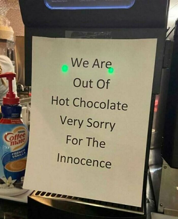 A sign on a coffee machine says, We Are Out Of Hot Chocolate Very Sorry For The Innocence, a cultural decline.