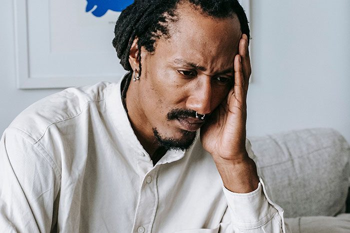 A man with dreadlocks and a nose ring looks thoughtful, perhaps reflecting on unfortunate names.
