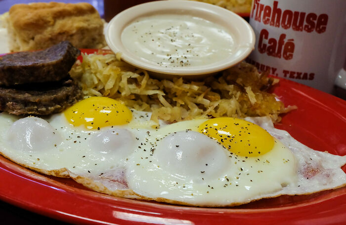 A plate with a full breakfast including eggs, hash browns, and sausage, a comforting contrast to public horror stories.