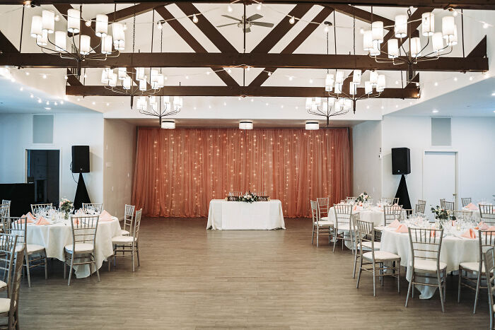 A beautifully decorated wedding venue with tables set for a reception, a wedding people regret spending money on.