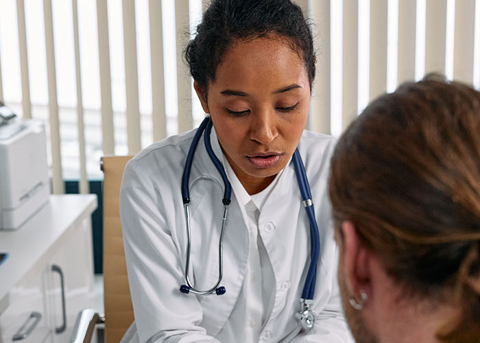 A doctor consults a patient, offering support for those feeling lonely on their birthdays.