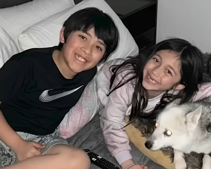 Two young people and a dog smiling, symbolizing the impact of the 16-year-old lifeguard's ocean rescue. Two young people and a dog smiling, symbolizing the impact of the 16-year-old lifeguard's ocean rescue.