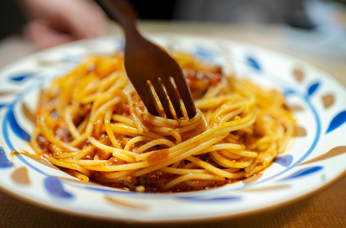 A close-up of spaghetti with a fork, perhaps a meal eaten after someone got fired from their job.