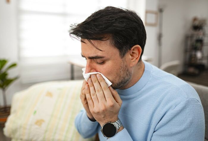 Man blowing nose with a tissue, one of the products that swapped audiences.