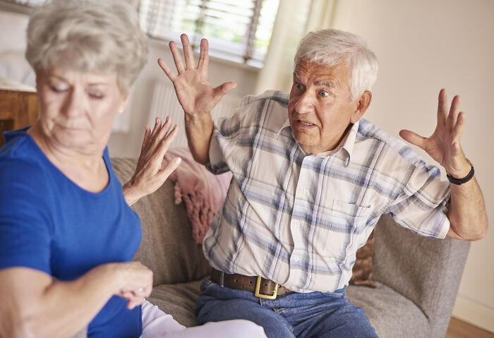 An older man with gray hair arguing with an older woman, expressing regret in age-gap relationships.