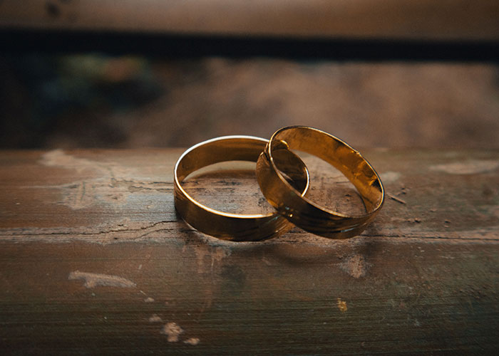 Two golden rings lie on a wooden surface. Many people swear they witnessed reality break for a second.