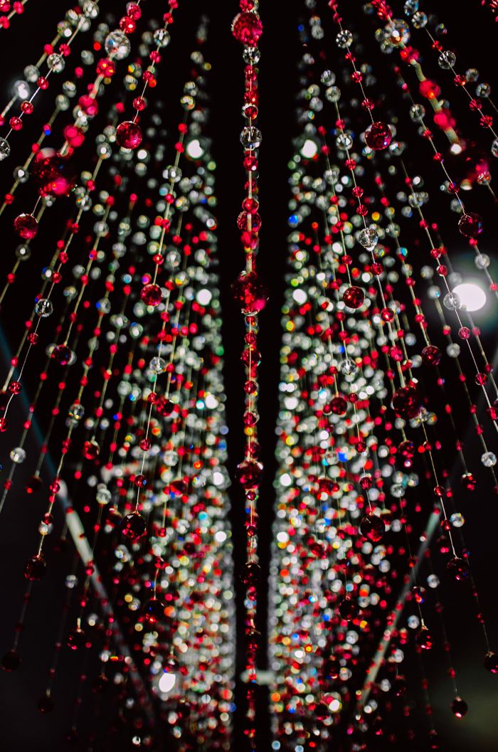 A display of red and clear beads hanging, creating a mysterious and creepy atmosphere for stories.