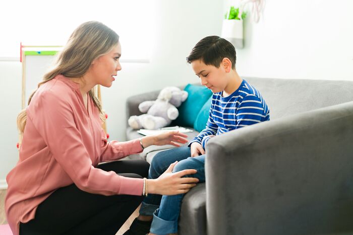 A therapist comforting a child who asked questions that stumped parents.