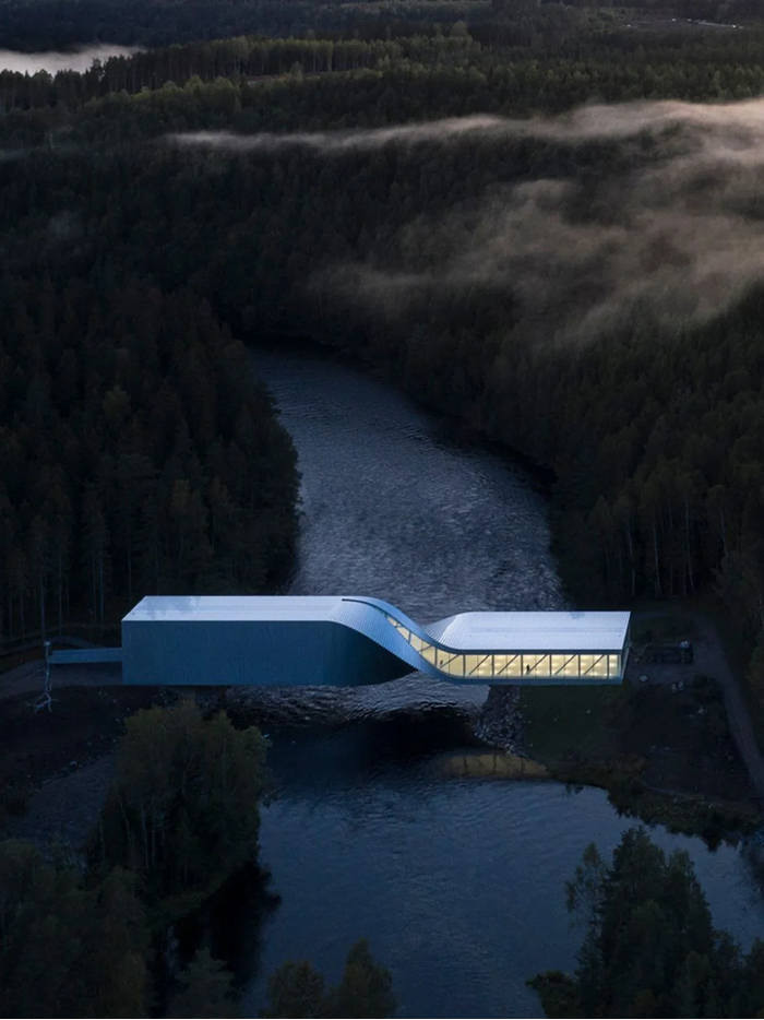 An aerial view of a sleek modern architecture design bridging a river in a dense, misty forest.