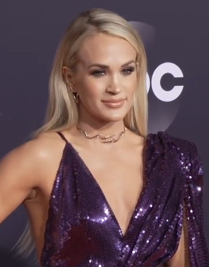 A blonde celebrity in a purple sequined dress, smiling subtly, capturing the essence of disillusioned celebrities.