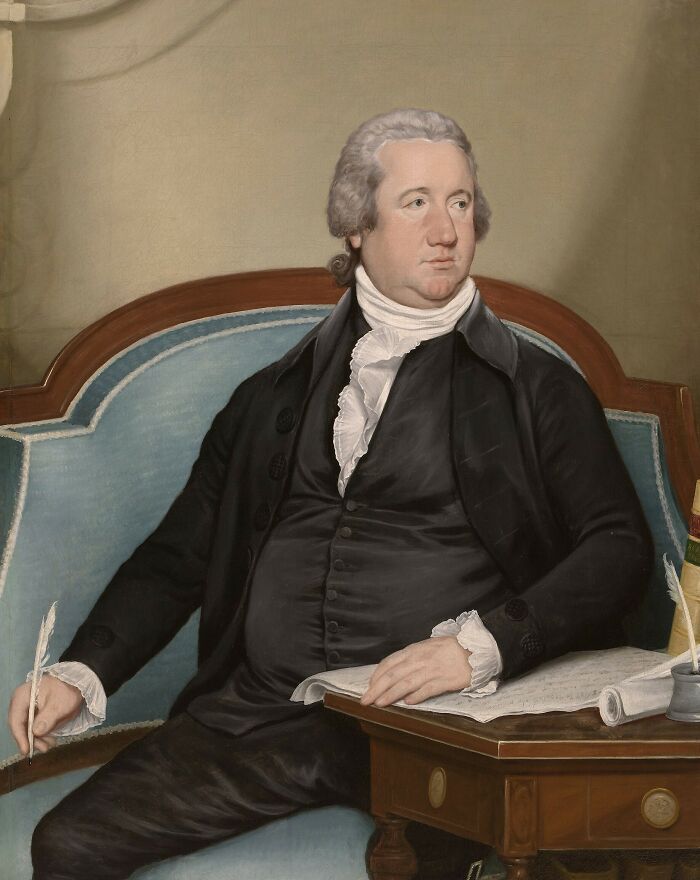 A historical painting of a man in a black coat and white ruffled shirt, seated at a desk with a quill, pondering historical myths.